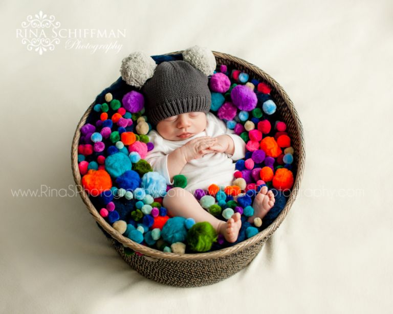 Adorable baby portrait with pom poms