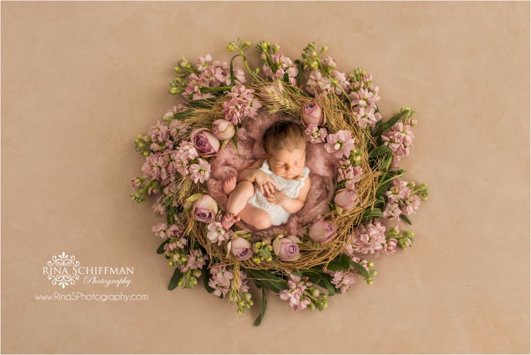 Newborn girl portrait with flowers